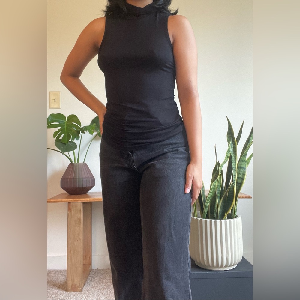 Black top with high neck. Model 5’0”- 110lbs for reference
